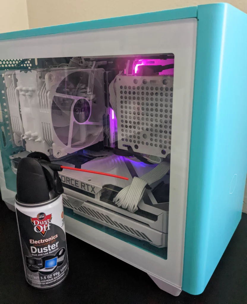 Clean your PC - A can of compressed air next to a Skytech Gaming Geode PC